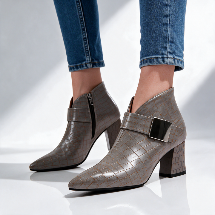 Taupe block heel ankle boots worn with blue jeans, front angle