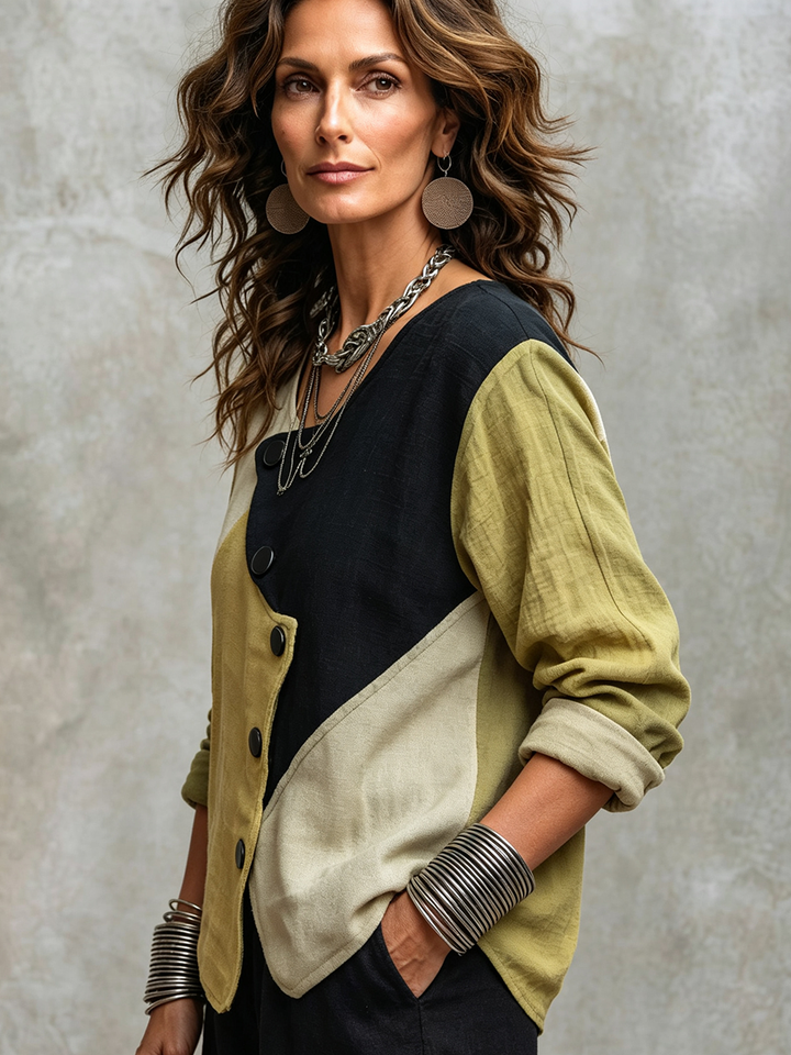 Side view of the colorblock top with rolled contrast cuffs and angled hem