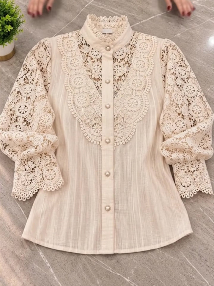 Beige lace blouse laid flat showing the scalloped lantern sleeves