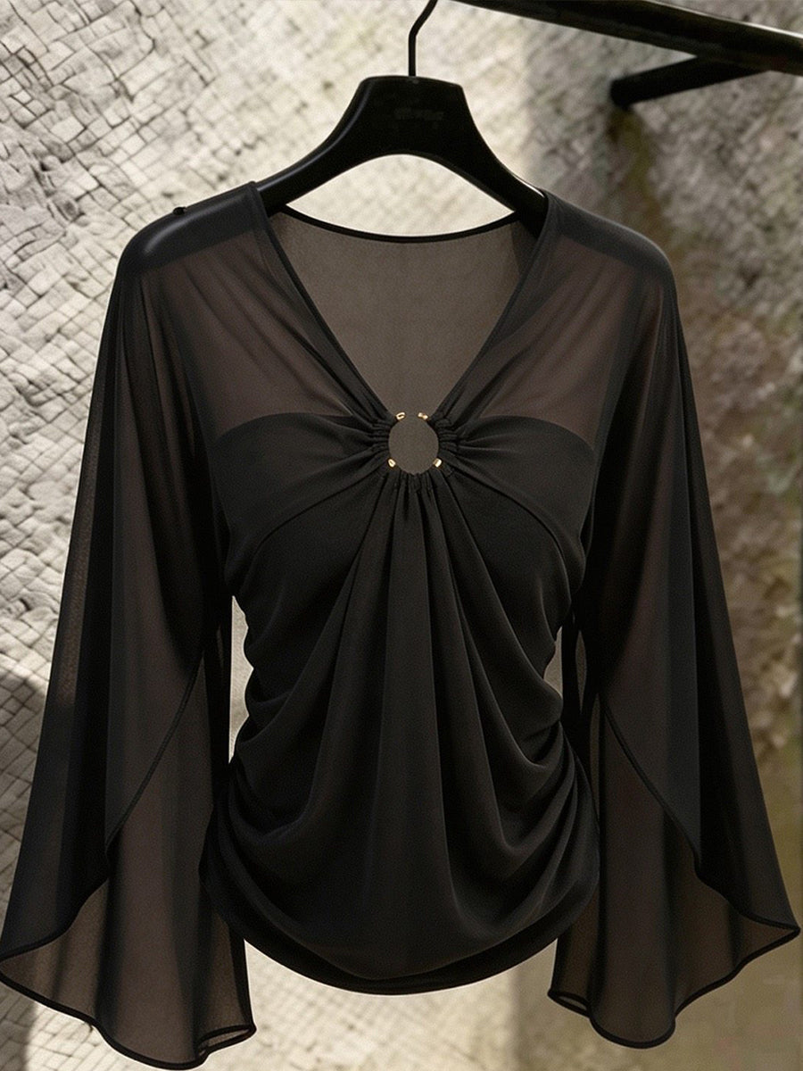 Black sheer sleeve blouse on a hanger showing the gold-tone ring detail
