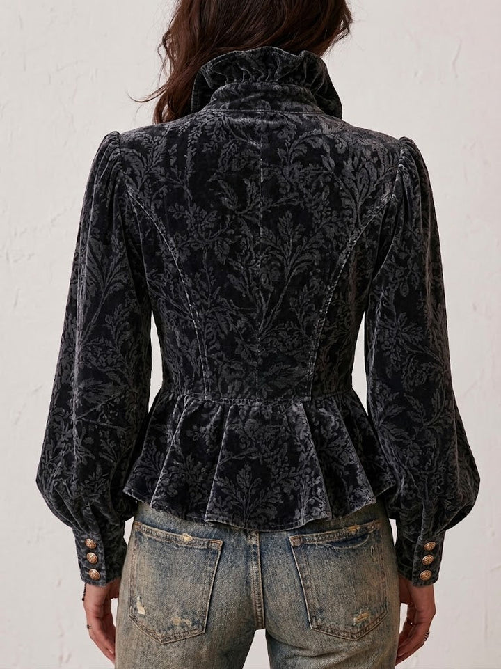 Back view of the fitted blouse with puff sleeves and buttoned cuffs