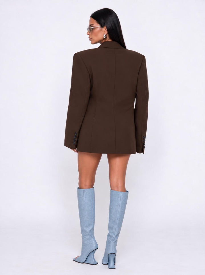 Back view of the dark brown boyfriend blazer worn with light blue boots