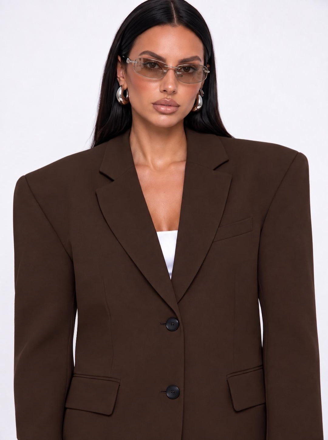 Close-up of the dark brown boyfriend blazer shoulders, lapels and two buttons