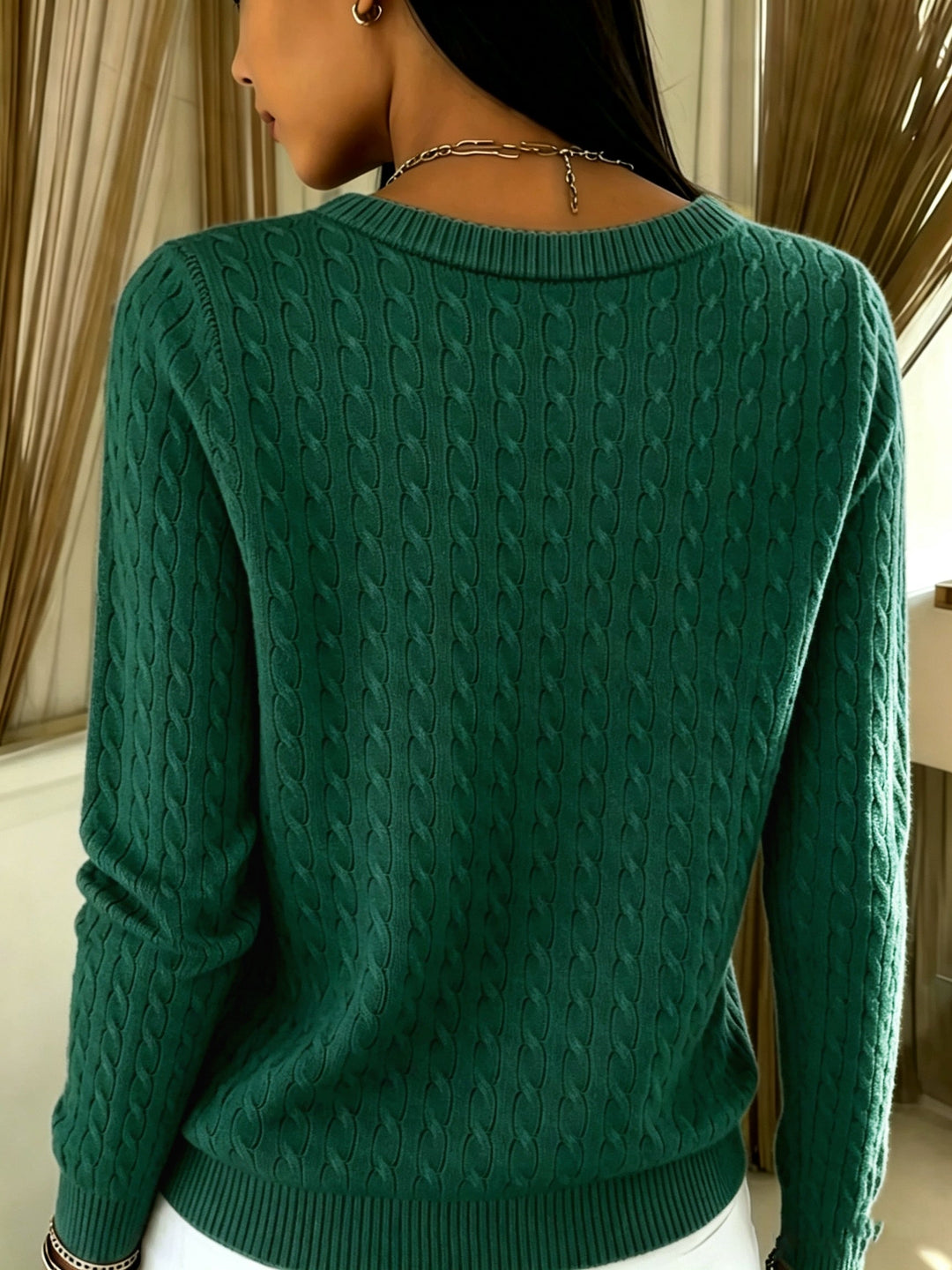 Back view of the forest green cable knit cardigan