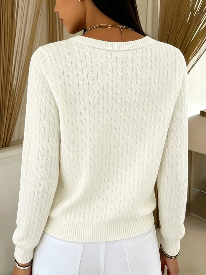 Back view of the ivory cable knit cardigan with ribbed hem