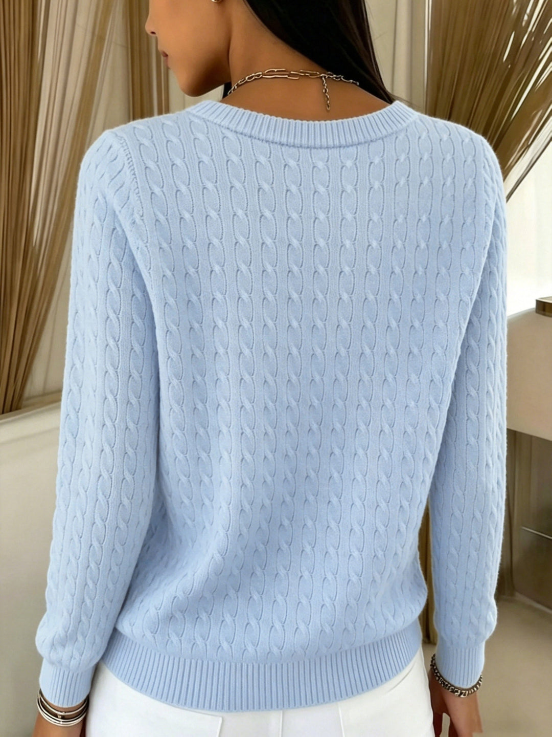 Back view of the light blue cable knit cardigan with crew neck