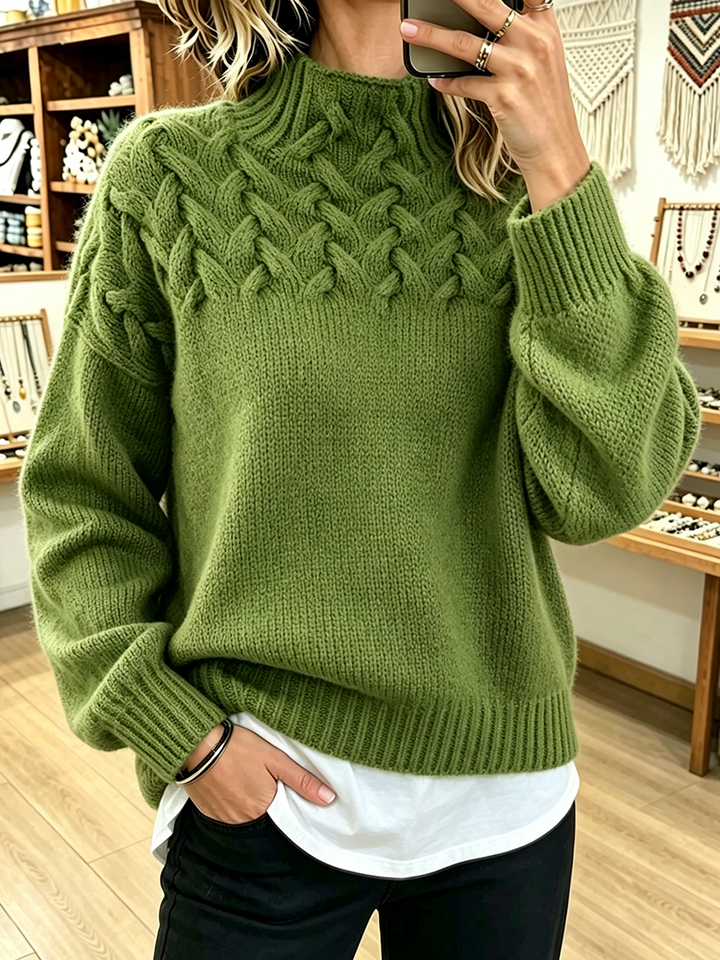 Moss green cable knit sweater with ribbed cuffs and relaxed fit