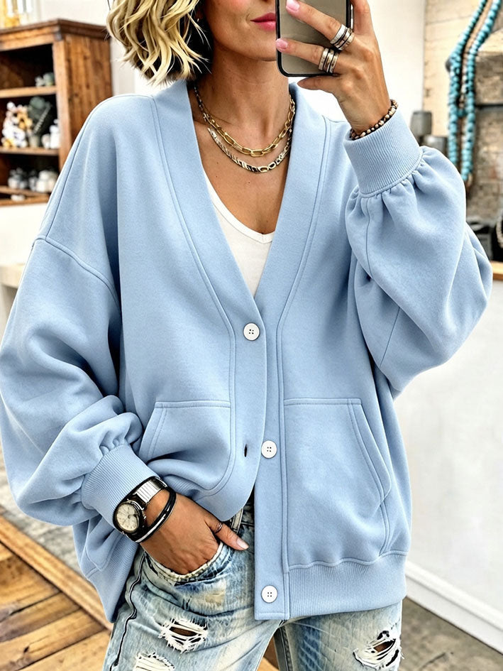Light blue V-neck cardigan worn open over a white tank