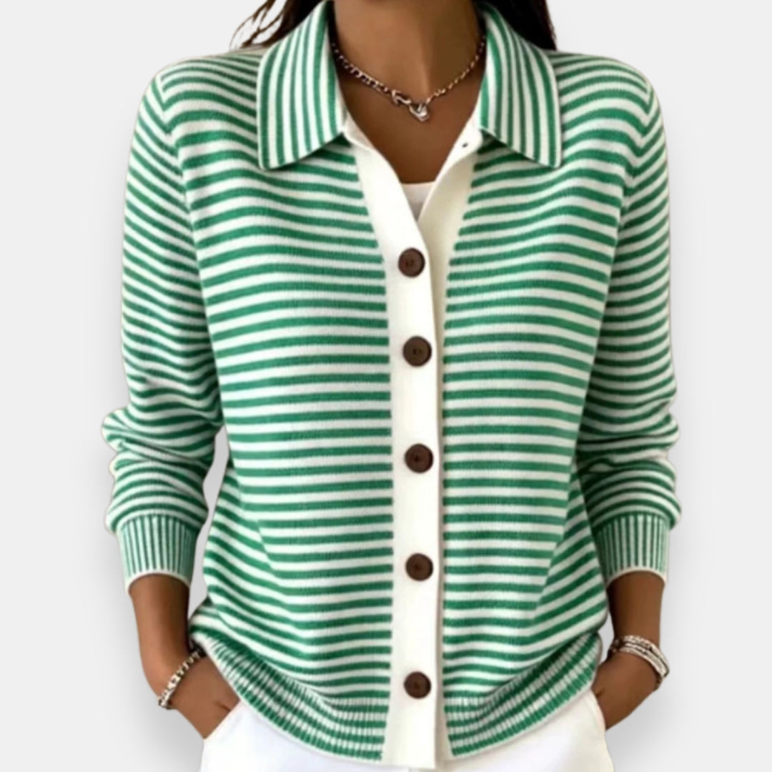 Green striped cardigan with polo collar and button front, worn with white pants
