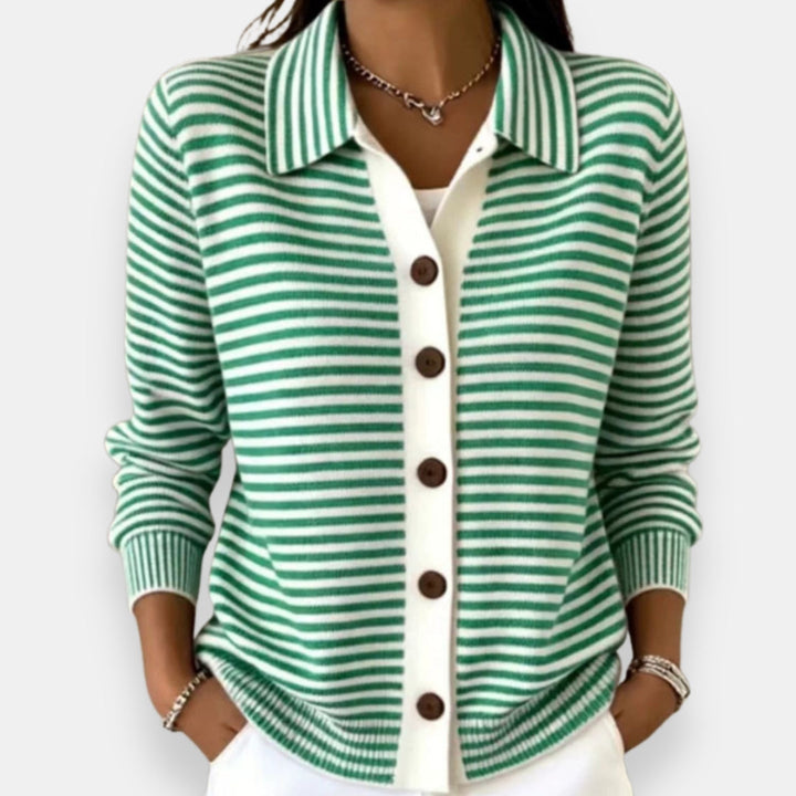 Green striped cardigan with polo collar and button front, worn with white pants