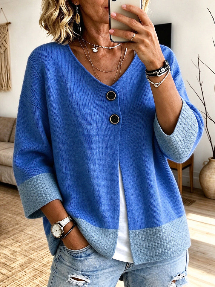 Blue cardigan with lighter blue cuffs and hem, styled with ripped denim
