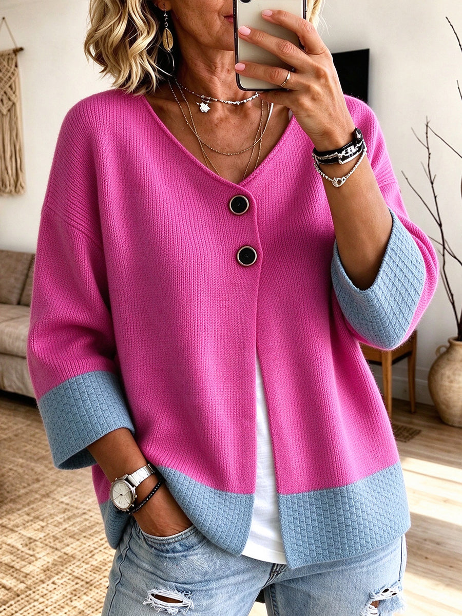 Hot pink cardigan with blue contrast trim worn over a white tank