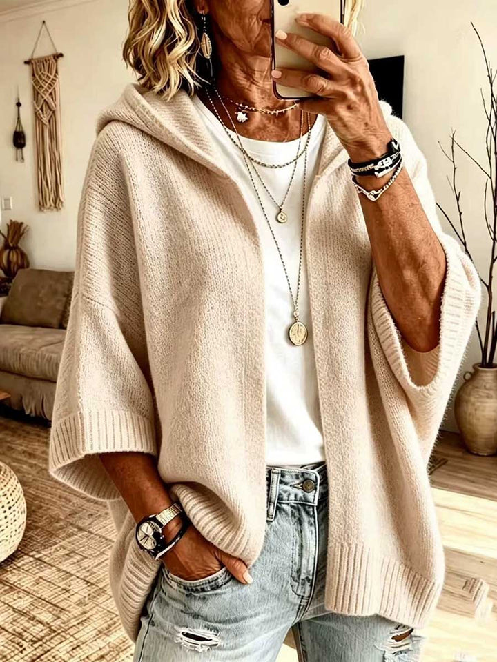 Beige hooded cardigan with relaxed drape and long necklaces