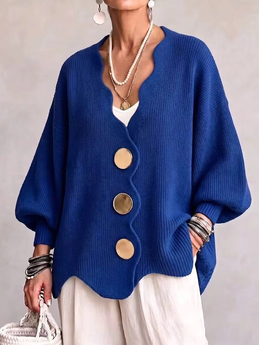 Bright blue oversized v neck cardigan with gold buttons and scalloped hem on a model