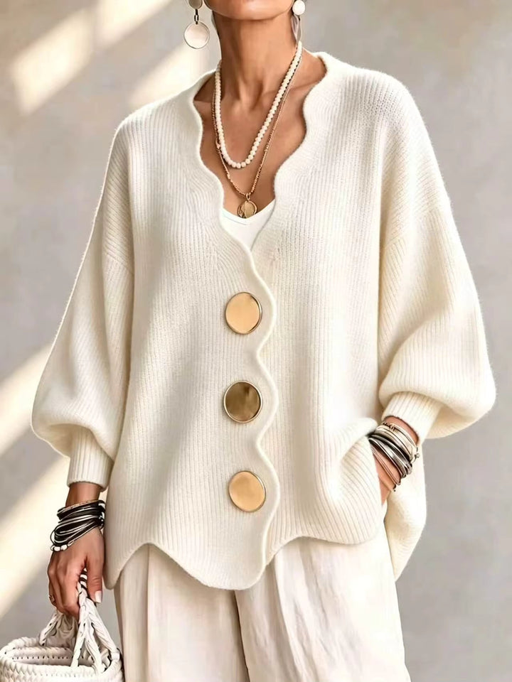 Cream oversized v neck cardigan with gold buttons and scalloped hem on a model
