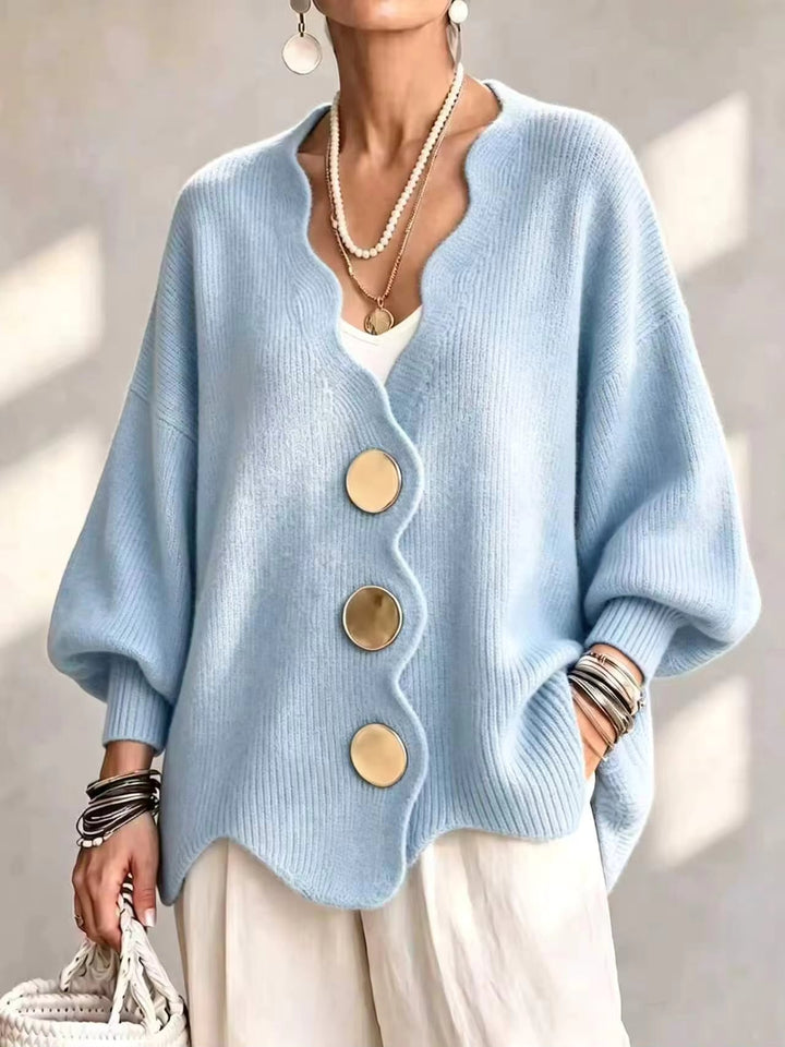 Light blue oversized v neck cardigan with gold buttons and scalloped hem on a model