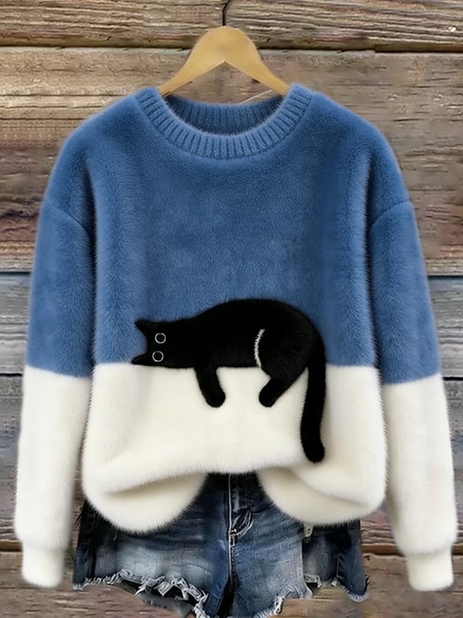 Darker denim blue cat sweater with white lower half, shown on a hanger