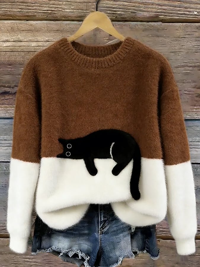 Brown two tone knit sweater with white lower half and a black cat design