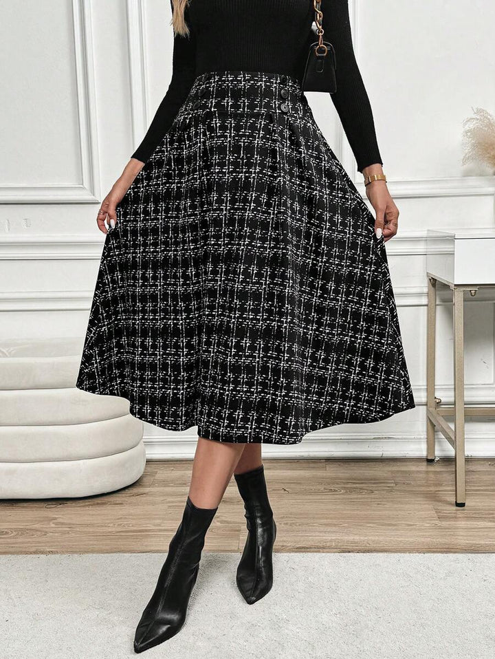 A-line tweed-look midi skirt with a flared hem, worn with pointed black boots