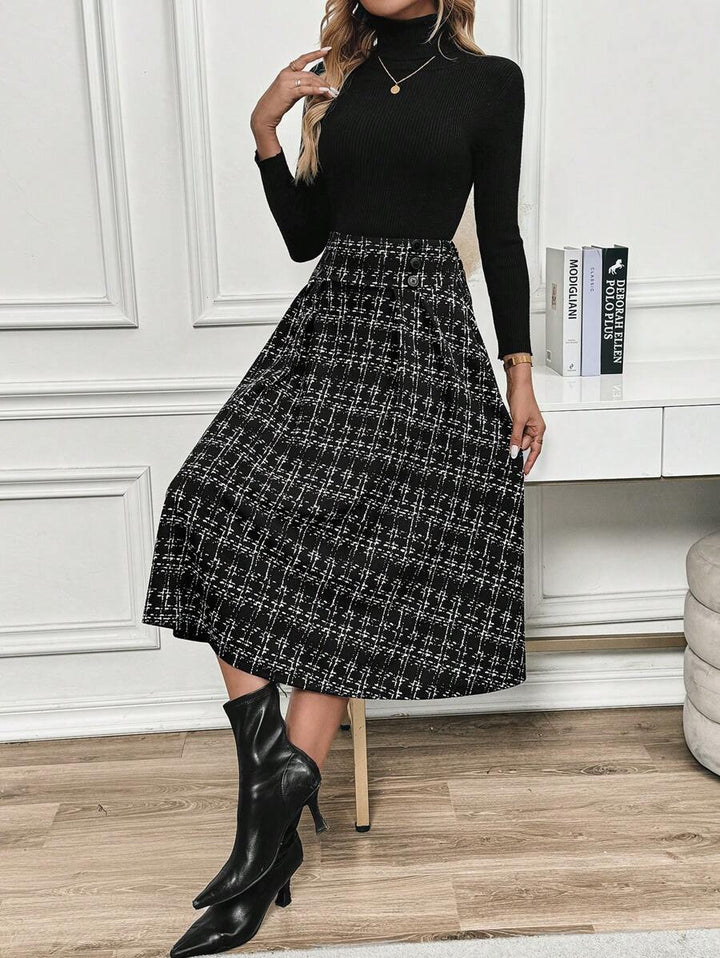 Black and white checkered skirt worn with a turtleneck, pendant necklace and heeled ankle boots