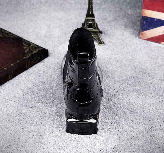 Back view of the black patent-look ankle boot with silver trimmed block heel