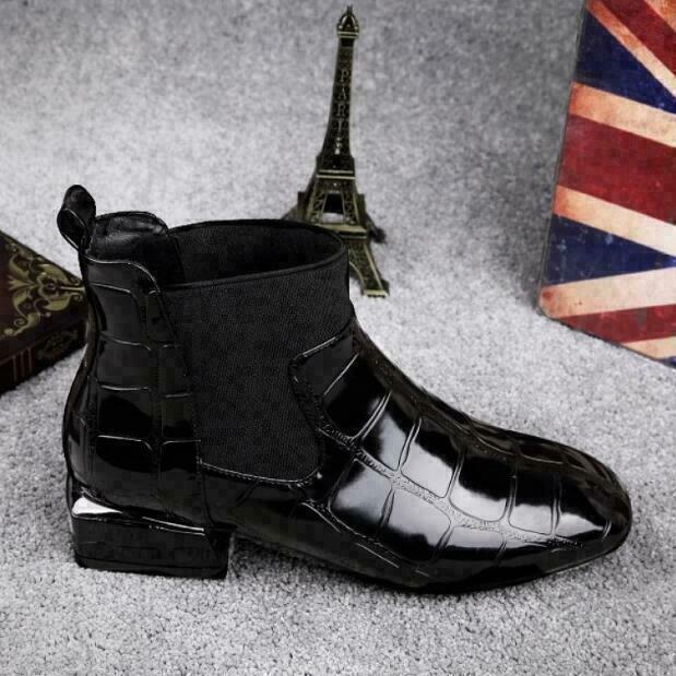 Black heeled ankle boot seen from the opposite side with elastic panel and pull tab