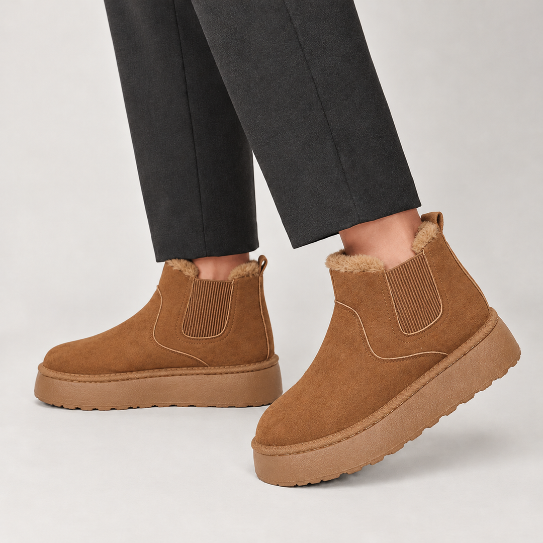 Brown mini chelsea boots worn with dark trousers