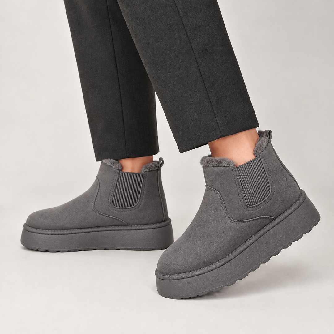 Women's chelsea boots in gray, platform mini style with fleece lining worn with trousers