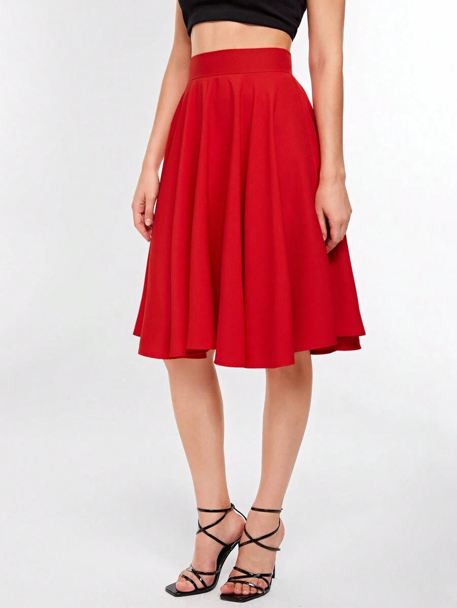 Red knee length skirt with wide waistband, straight front view while standing