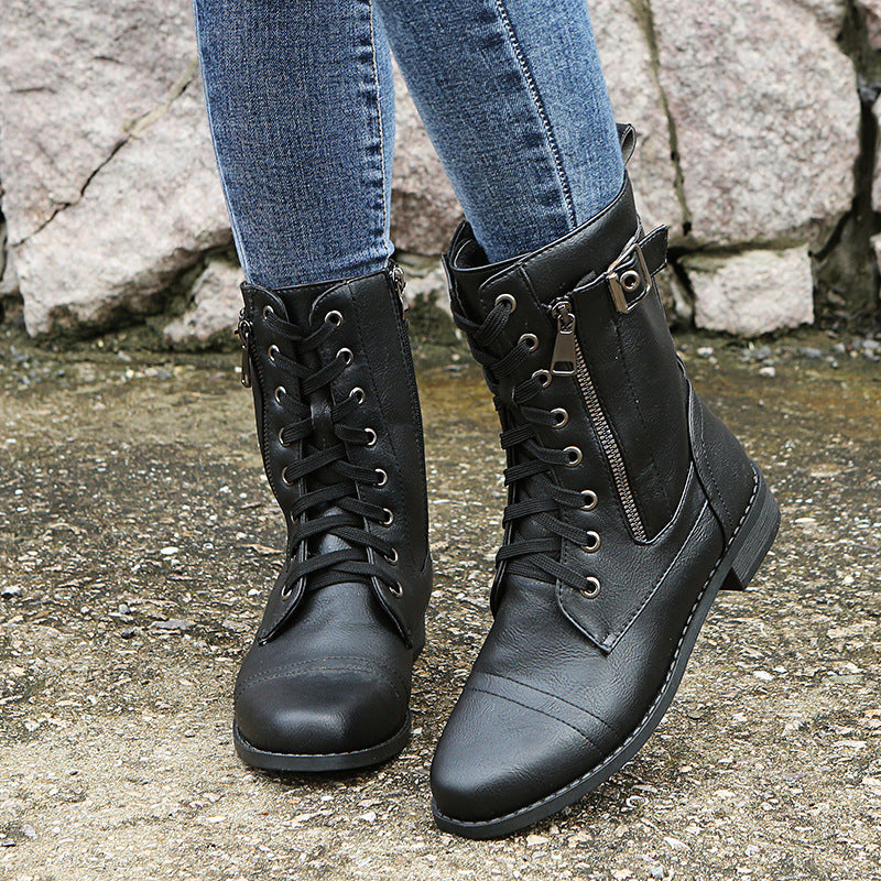 Black combat ankle booties with laces and side zip worn with jeans