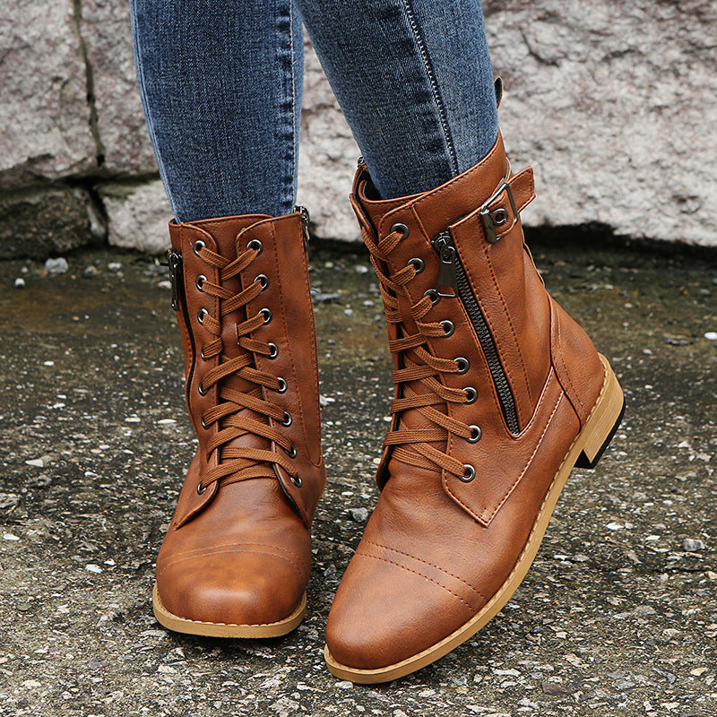 Front view of cognac lace up combat boots with side zip worn with jeans