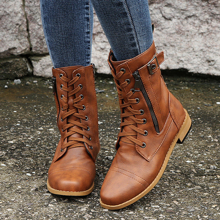 Front view of cognac lace up combat boots with side zip worn with jeans