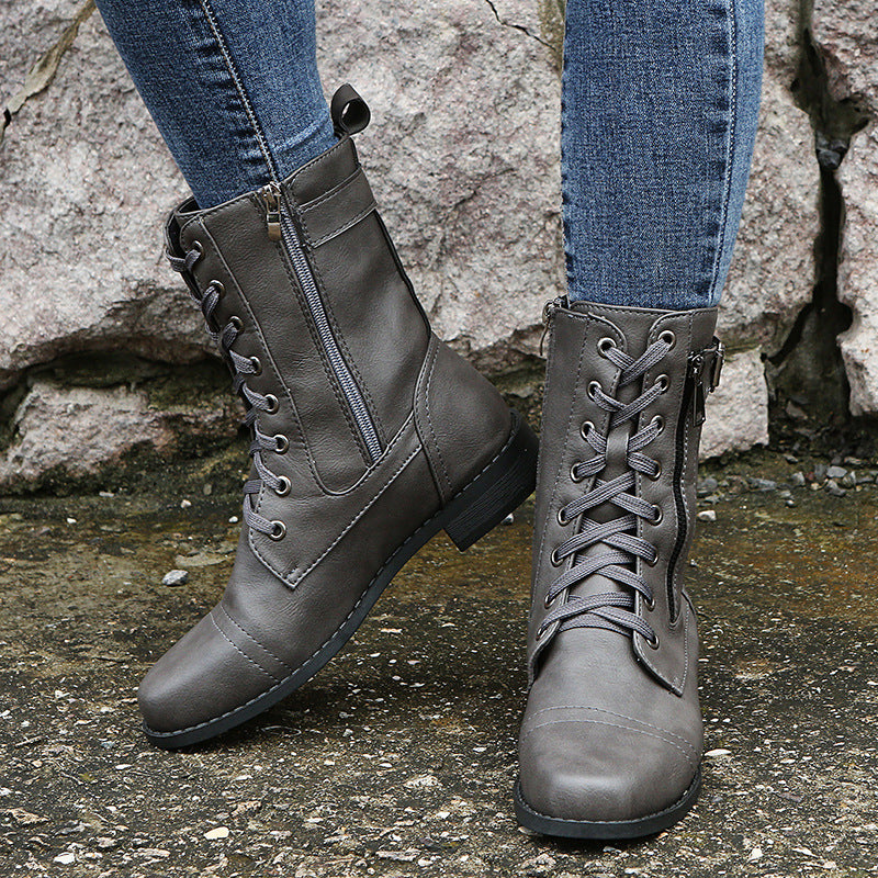Gray combat boots with lacing and side zip, pair worn with jeans