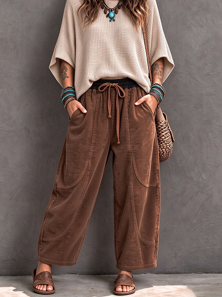 Brown corduroy barrel pants worn with a loose cream knit and sandals