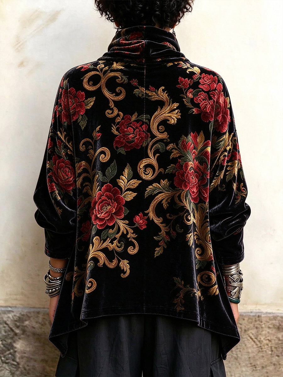 Back of the floral cowl neck top showing the pointed side hem and loose sleeves