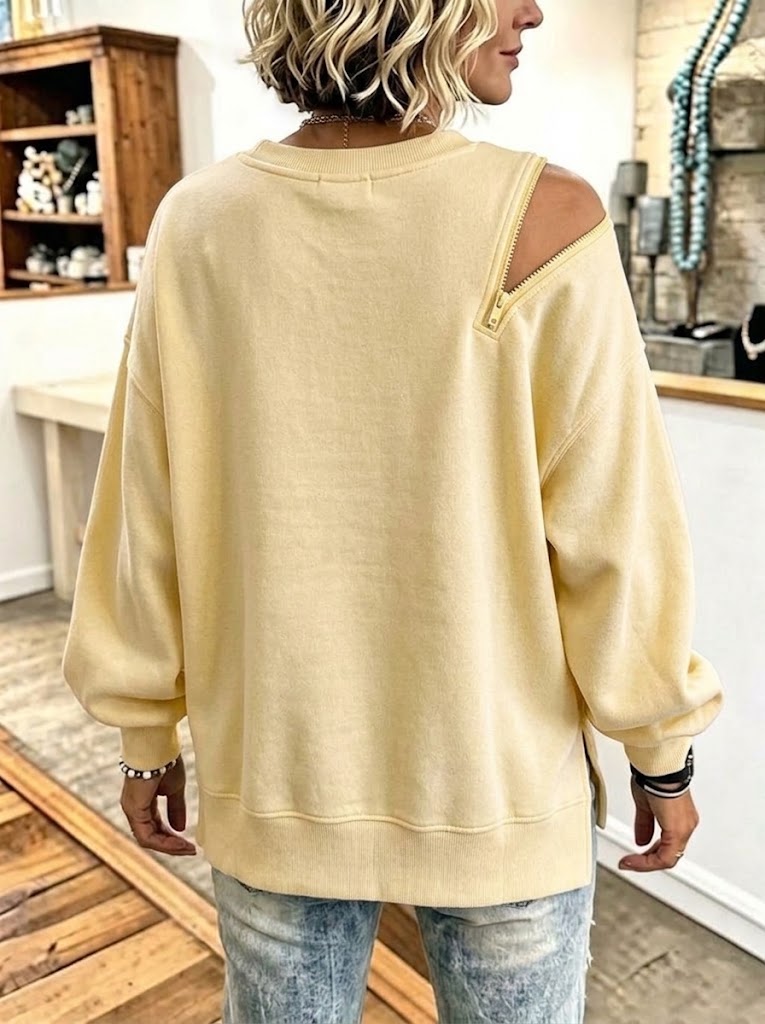 Pale yellow sweatshirt from the back showing the relaxed drop-shoulder fit