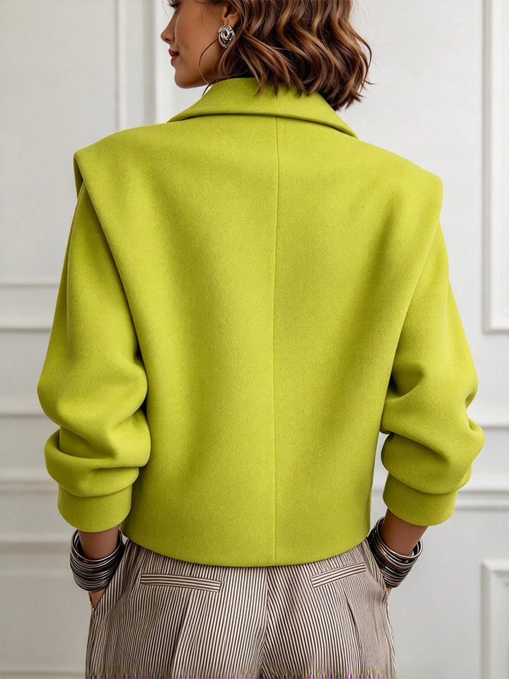 Back of the lime green cropped jacket showing the boxy shape and center seam