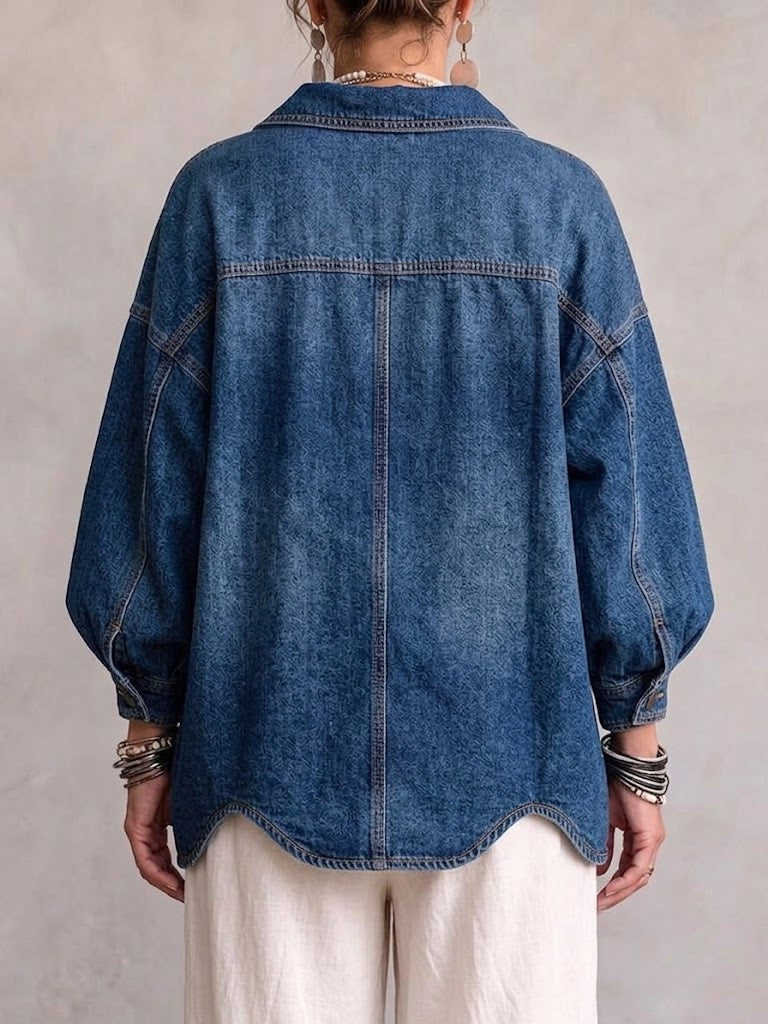 Back view of the washed blue jacket with yoke seam and scalloped hem