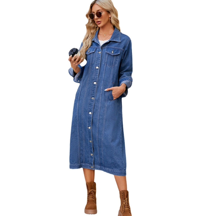 Blue denim trench coat buttoned up on a white background, hand in side pocket