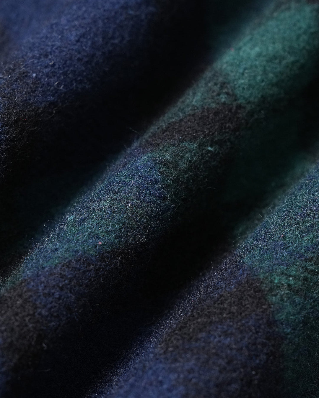 Close up of the green and navy plaid pattern on the mini skirt