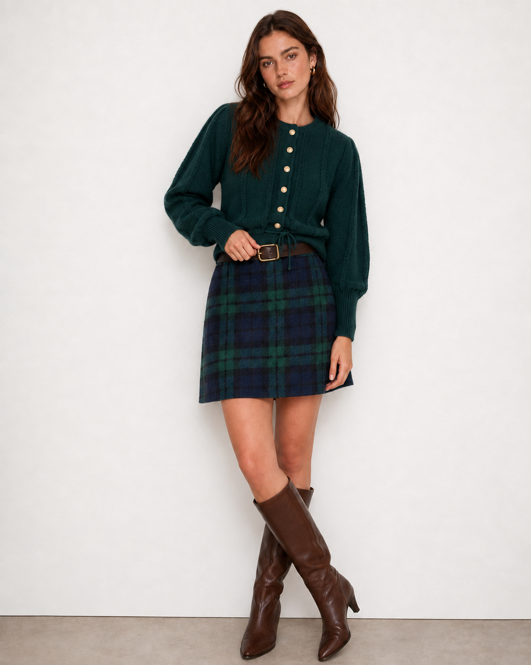 Full length view of the green plaid mini skirt with a green cardigan and tall brown boots