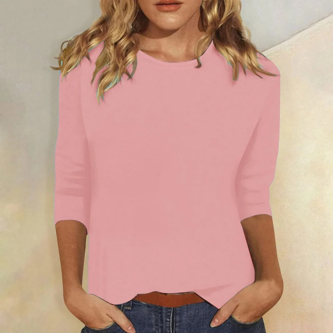 Women's pink three quarter sleeve top, front view on a model