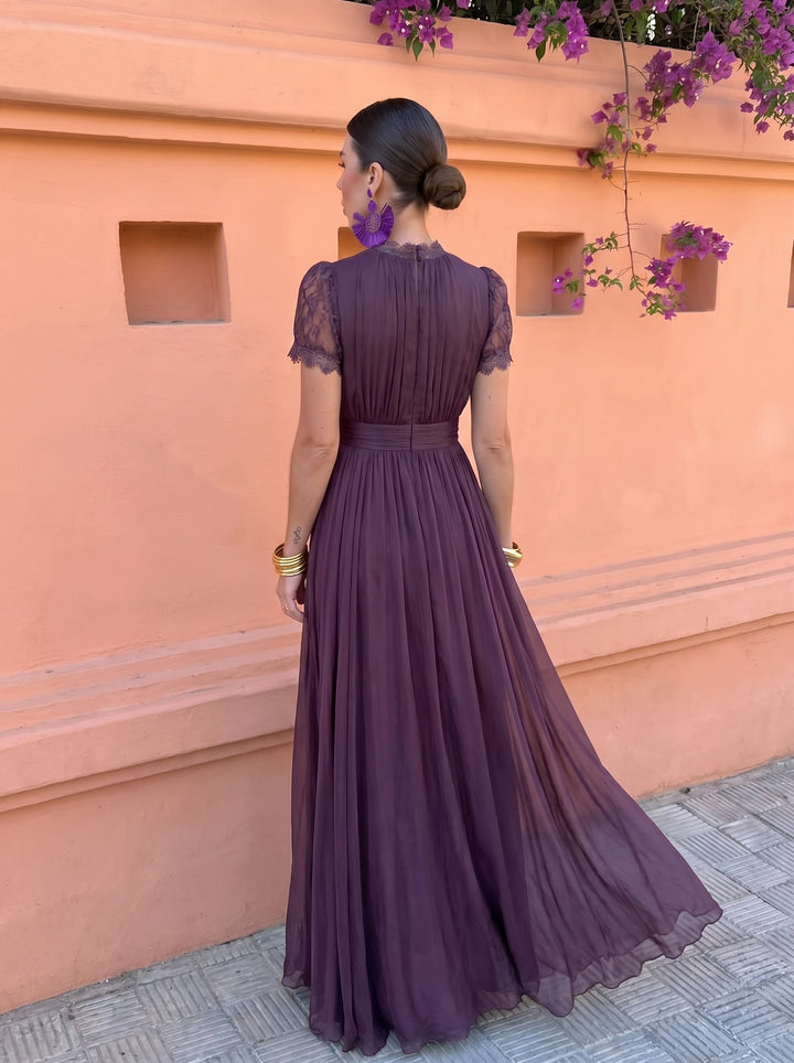 Back view of the plum pleated maxi dress with flowing skirt