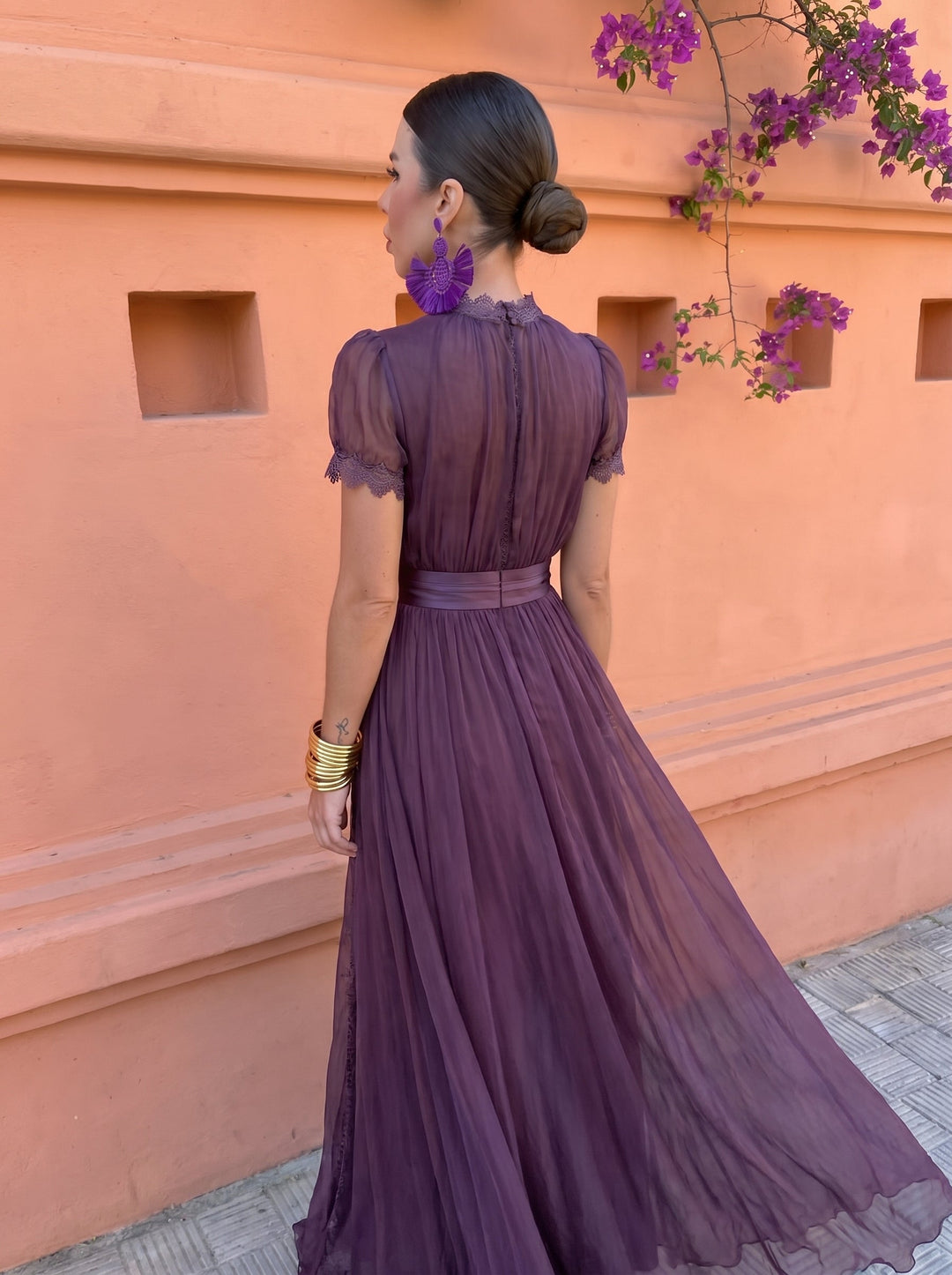 Side back angle of the maxi dress showing the sheer sleeves and waistband