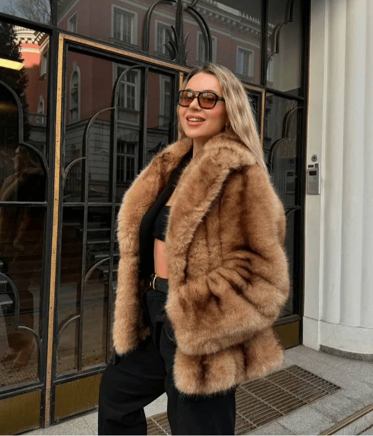 Three quarter view of the caramel faux fur coat with wide lapel collar