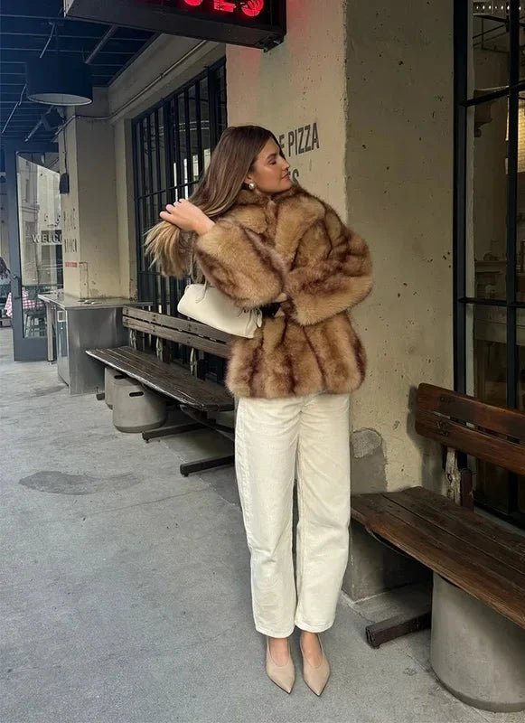 Model walking in the caramel short faux fur coat and white jeans