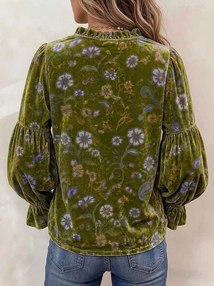 Back view of the olive blouse showing the full lantern sleeves and floral print