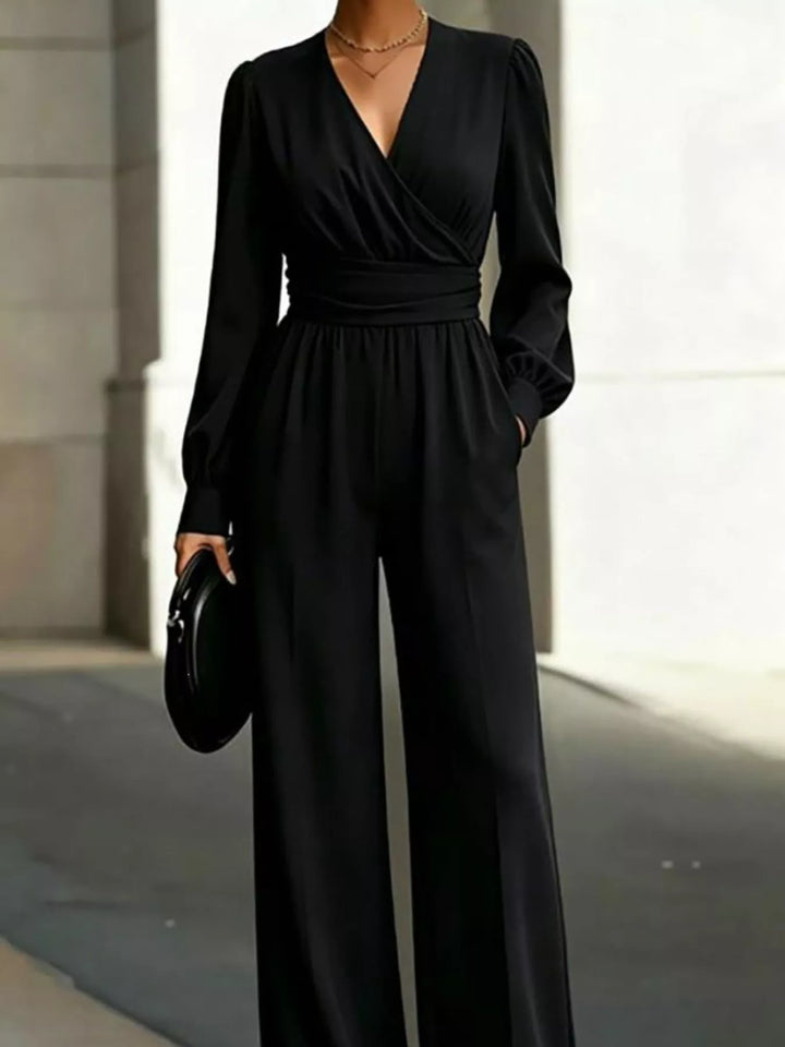 Black wrap jumpsuit with hand in the side pocket