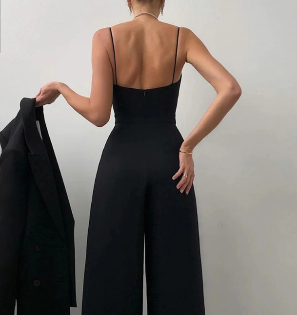 Back view of the black jumpsuit with thin straps and open shoulders