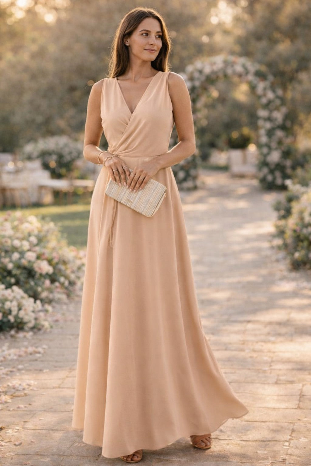 Beige sleeveless gown with a fitted waist and full skirt